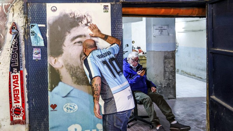 Soccer fans carry a banner of Diego Maradona in downtown Buenos Aires, Argentina, Wednesday, Nov. 25, 2020. Diego Maradona, the Argentine soccer great who was among the best players ever and who led his country to the 1986 World Cup title died from a heart attack at his home in Buenos Aires. He was 60. (AP Photo/Victor Caivano)