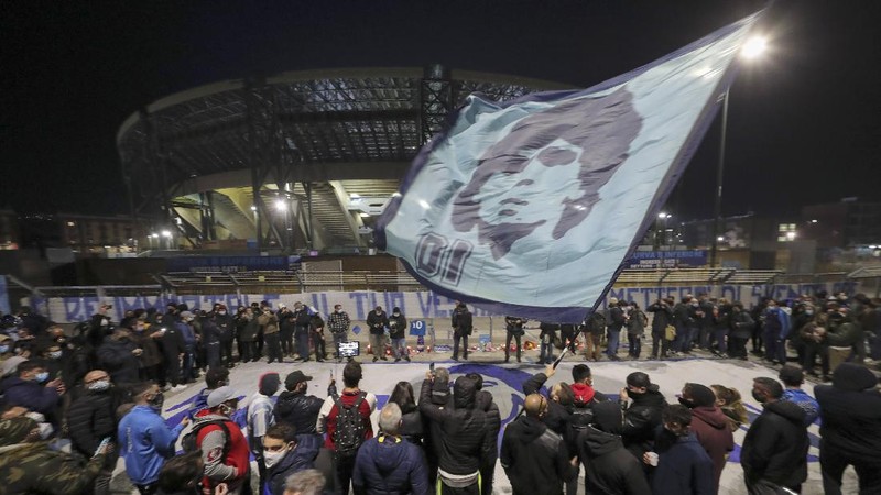 Soccer fans carry a banner of Diego Maradona in downtown Buenos Aires, Argentina, Wednesday, Nov. 25, 2020. Diego Maradona, the Argentine soccer great who was among the best players ever and who led his country to the 1986 World Cup title died from a heart attack at his home in Buenos Aires. He was 60. (AP Photo/Victor Caivano)