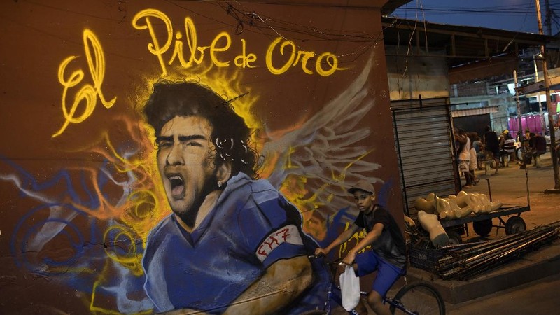 Soccer fans carry a banner of Diego Maradona in downtown Buenos Aires, Argentina, Wednesday, Nov. 25, 2020. Diego Maradona, the Argentine soccer great who was among the best players ever and who led his country to the 1986 World Cup title died from a heart attack at his home in Buenos Aires. He was 60. (AP Photo/Victor Caivano)