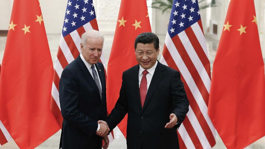 FILE - In this Dec. 4, 2013, file photo, Chinese President Xi Jinping, right, shakes hands with then U.S. Vice President Joe Biden as they pose for photos at the Great Hall of the People in Beijing. As Americans celebrate or fume over the new president-elect, many in Asia are waking up to the reality of a Joe Biden administration with decidedly mixed feelings. Relief and hopes of economic and environmental revival jostle with needling anxiety and fears of inattention. The two nations are inexorably entwined, economically and politically, even as the U.S. military presence in the Pacific chafes against China’s expanded effort to have its way in what it sees as its natural sphere of influence. (AP Photo/Lintao Zhang, Pool, File)