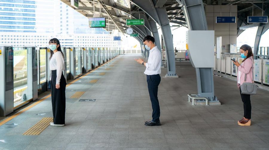 Three Asian people wearing mask standing distance of 1 meter from other people keep distance protect from COVID-19 viruses and people social distancing  for infection risk and disease prevention measures.
