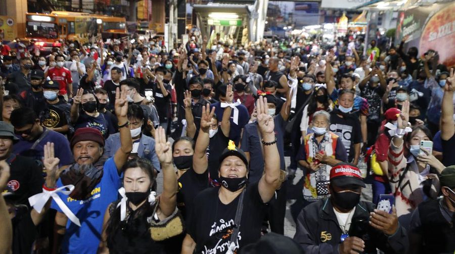 A crowd of protesters march in Bangkok, Thailand, Saturday, Nov. 28, 2020. Pro-democracy demonstrators are continuing their protests calling for the government to step down and reforms to the constitution and the monarchy, despite legal charges being filed against them and the possibility of violence from their opponents or a military crackdown. (AP Photo/Sakchai Lalit)