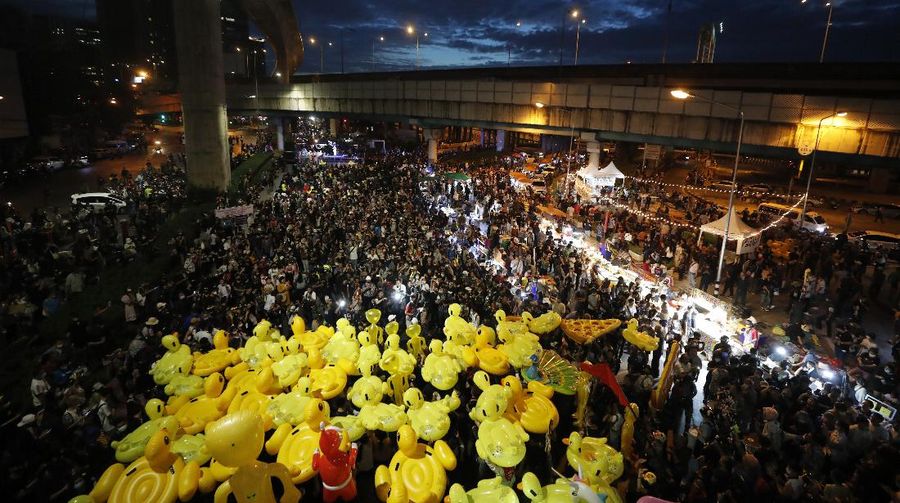 A crowd of protesters march in Bangkok, Thailand, Saturday, Nov. 28, 2020. Pro-democracy demonstrators are continuing their protests calling for the government to step down and reforms to the constitution and the monarchy, despite legal charges being filed against them and the possibility of violence from their opponents or a military crackdown. (AP Photo/Sakchai Lalit)