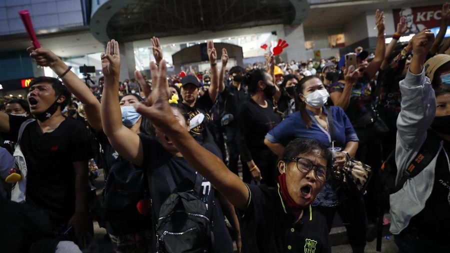 A crowd of protesters march in Bangkok, Thailand, Saturday, Nov. 28, 2020. Pro-democracy demonstrators are continuing their protests calling for the government to step down and reforms to the constitution and the monarchy, despite legal charges being filed against them and the possibility of violence from their opponents or a military crackdown. (AP Photo/Sakchai Lalit)