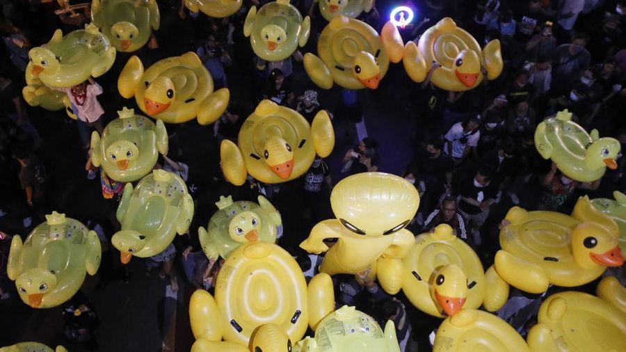 A crowd of protesters march in Bangkok, Thailand, Saturday, Nov. 28, 2020. Pro-democracy demonstrators are continuing their protests calling for the government to step down and reforms to the constitution and the monarchy, despite legal charges being filed against them and the possibility of violence from their opponents or a military crackdown. (AP Photo/Sakchai Lalit)