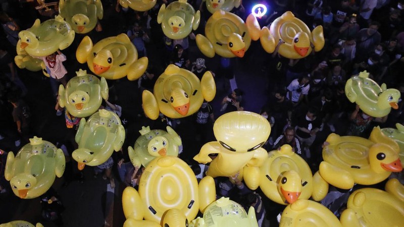 A crowd of protesters march in Bangkok, Thailand, Saturday, Nov. 28, 2020. Pro-democracy demonstrators are continuing their protests calling for the government to step down and reforms to the constitution and the monarchy, despite legal charges being filed against them and the possibility of violence from their opponents or a military crackdown. (AP Photo/Sakchai Lalit)
