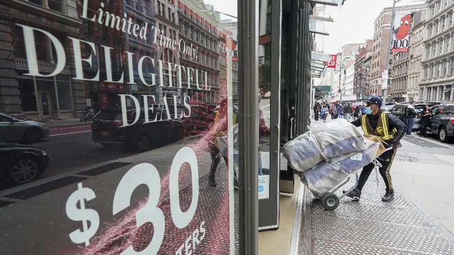 Shoppers wait in line at an electronics store in Calgary, Alberta, Friday, Nov. 27, 2020, amid a worldwide COVID-19 pandemic. (Jeff McIntosh/The Canadian Press via AP)