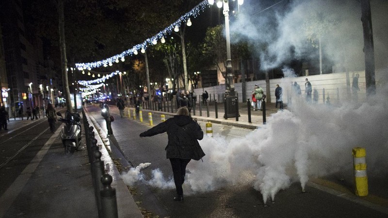 Protesters hold signs during a demonstration against a security law that would restrict sharing images of police, Saturday, Nov. 28, 2020 in Marseille. Civil liberties groups and journalists are concerned that the measure will stymie press freedoms and allow police brutality to go undiscovered and unpunished. The cause has gained fresh impetus in recent days after footage emerged of French police officers beating up a Black man, triggering a nationwide outcry. (AP Photo/Daniel Cole)