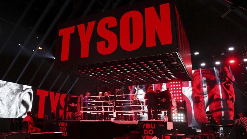 In a photo provided by Triller, Mike Tyson throws a punch during the fourth round against Roy Jones Jr. in an exhibition boxing bout Saturday, Nov. 28, 2020, in Los Angeles. The bout was unofficially ruled a draw by the WBC judges at ringside. Tyson and Jones fought eight two-minute rounds, and both emerged smiling and apparently healthy from a highly unusual event. (Joe Scarnici/Triller via AP)