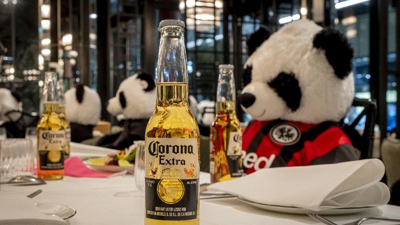 Plush pandas and Corona beer bottles decorate the tables of a closed restaurant in Frankfurt, Germany, Tuesday, Nov. 24, 2020. Restaurants all over Germany were closed as a partial lockdown began in November to avoid the further outspread of the coronavirus. (AP Photo/Michael Probst)