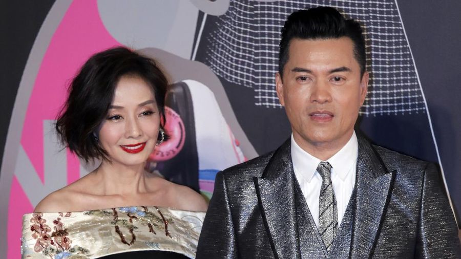 Hong Kong actress Teresa Mo, left, and actor Ray Lui Leung-wai pose on the red carpet of the Hong Kong Film Awards in Hong Kong, Sunday, April 15, 2018. (AP Photo/Vincent Yu)