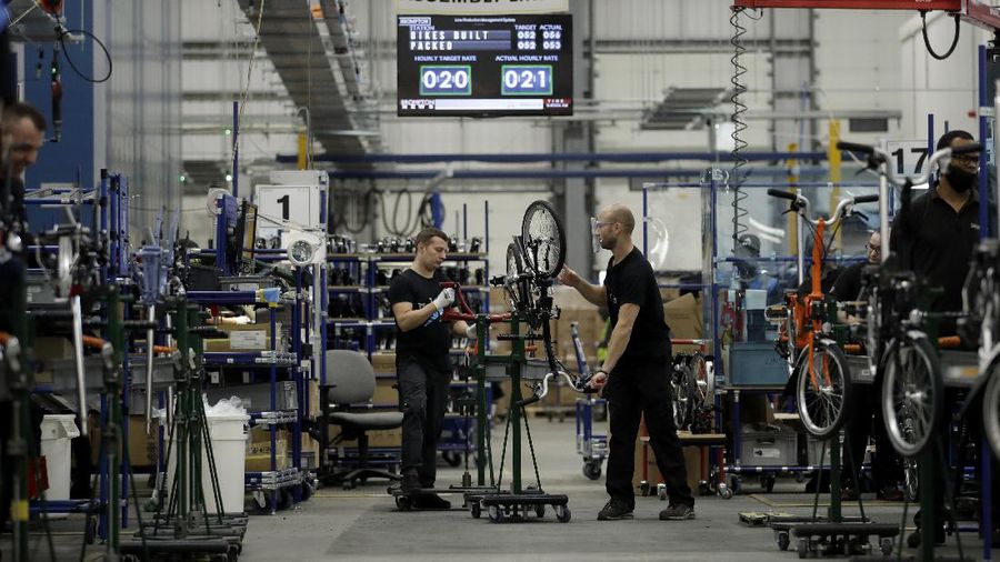 Brompton folding bicycles are assembled by hand at the Brompton factory in west London, Tuesday, Nov. 24, 2020.  The team at Brompton Bicycles company thought they were prepared for Britain's Brexit split with Europe, but they face uncertainty about supplies and unexpected new competition from China, all amid a global COVID pandemic.(AP Photo/Matt Dunham)