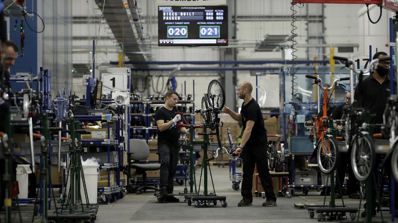 Brompton folding bicycles are assembled by hand at the Brompton factory in west London, Tuesday, Nov. 24, 2020.  The team at Brompton Bicycles company thought they were prepared for Britain's Brexit split with Europe, but they face uncertainty about supplies and unexpected new competition from China, all amid a global COVID pandemic.(AP Photo/Matt Dunham)