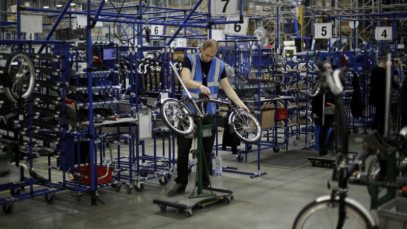 Brompton folding bicycles are assembled by hand at the Brompton factory in west London, Tuesday, Nov. 24, 2020.  The team at Brompton Bicycles company thought they were prepared for Britain's Brexit split with Europe, but they face uncertainty about supplies and unexpected new competition from China, all amid a global COVID pandemic.(AP Photo/Matt Dunham)