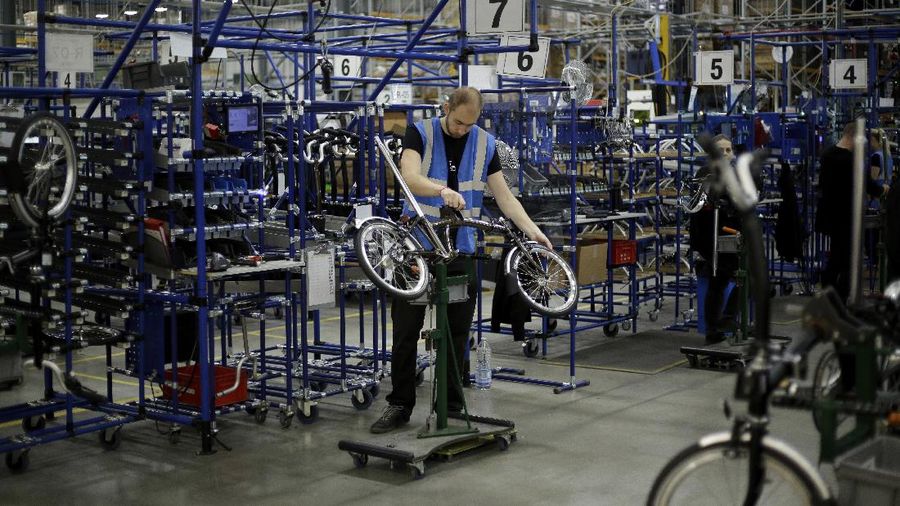 Brompton folding bicycles are assembled by hand at the Brompton factory in west London, Tuesday, Nov. 24, 2020. The team at Brompton Bicycles company thought they were prepared for Britain's Brexit split with Europe, but they face uncertainty about supplies and unexpected new competition from China, all amid a global COVID pandemic.(AP Photo/Matt Dunham)