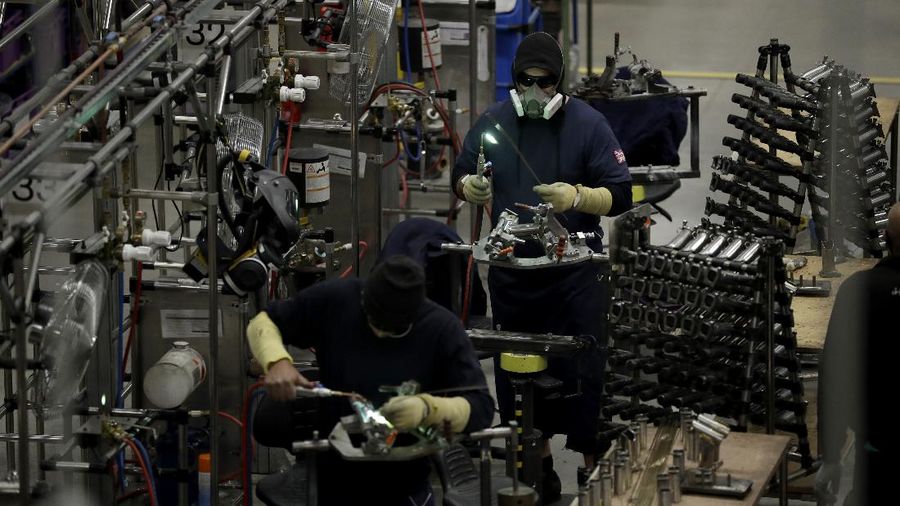 Brompton folding bicycles are assembled by hand at the Brompton factory in west London, Tuesday, Nov. 24, 2020.  The team at Brompton Bicycles company thought they were prepared for Britain's Brexit split with Europe, but they face uncertainty about supplies and unexpected new competition from China, all amid a global COVID pandemic.(AP Photo/Matt Dunham)