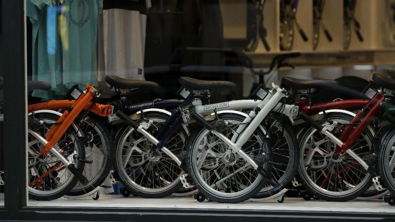 Brompton folding bicycles are assembled by hand at the Brompton factory in west London, Tuesday, Nov. 24, 2020.  The team at Brompton Bicycles company thought they were prepared for Britain's Brexit split with Europe, but they face uncertainty about supplies and unexpected new competition from China, all amid a global COVID pandemic.(AP Photo/Matt Dunham)