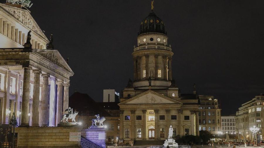 This combination image shows a file photo dated Monday, Nov. 25, 2013, of the Gendarmenmarkt square with the traditional Christmas Market in Berlin Germany, top, and the square on Monday, Nov. 23, 2020, below. Christmas markets, a cherished tradition in Germany and neighboring countries, have joined the long list of institutions canceled or diminished because of the coronavirus pandemic this year. (AP Photo/Markus Schreiber, file)