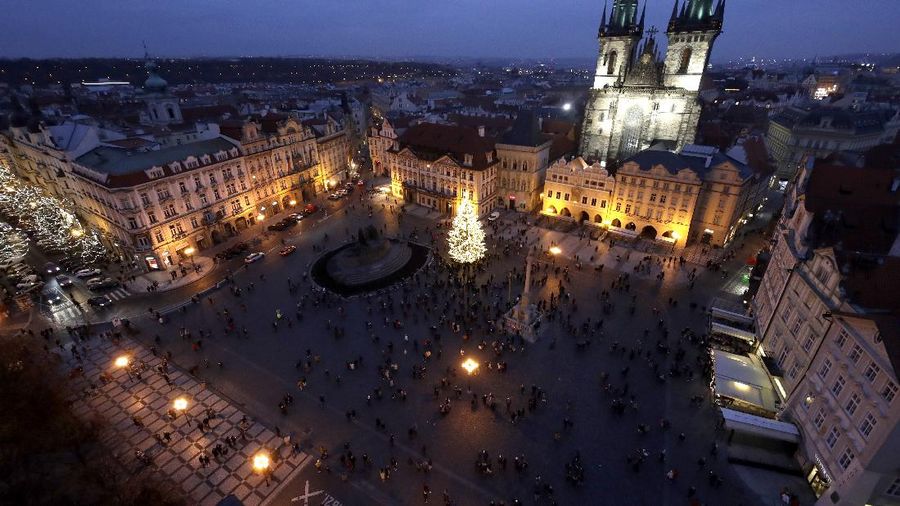 A Christmas tree illuminates the Old Town Square in Prague, Czech Republic, Saturday, Nov. 28, 2020. Prague city hall has lit up the Christmas Tre but cancelled the traditional Christmas markets due to a record surge in coronavirus infections. (AP Photo/Petr David Josek)