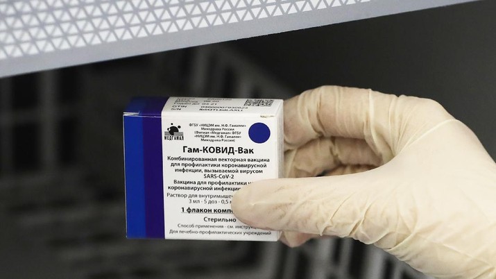 A medical worker moves a box of Russia's Sputnik V coronavirus vaccine out from a refrigerator prior to administering a vaccination in Moscow, Russia, Saturday, Dec. 5, 2020. Thousands of doctors, teachers and others in high-risk groups have signed up for COVID-19 vaccinations in Moscow starting Saturday, a precursor to a sweeping Russia-wide immunization effort. (AP Photo/Pavel Golovkin)