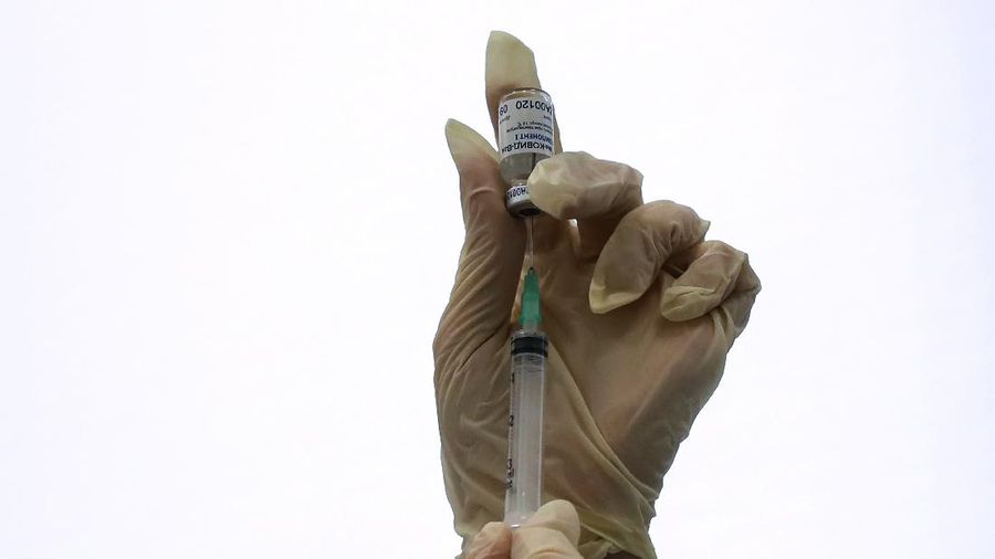 A Russian medical worker prepares a shot of Russia's Sputnik V coronavirus vaccine in Moscow, Russia, Saturday, Dec. 5, 2020. Thousands of doctors, teachers and others in high-risk groups have signed up for COVID-19 vaccinations in Moscow starting Saturday, a precursor to a sweeping Russia-wide immunization effort. (AP Photo/Pavel Golovkin)