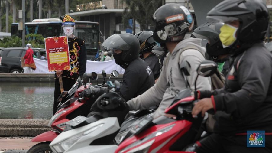 Aksi warga mengenakan pakaian adat menyerukan ajakan patuhi aturan Covid-19 saat Pilkada berlangsung disejumlah daerah di Kawasan Patung Kuda Monas, Jakarta, Senin 7/12. (CNBC Indonesia/Muhammad Sabki)