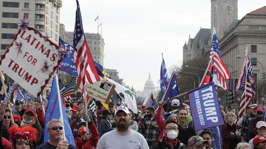 A supporter of President Donald Trump attends a rally at Freedom Plaza, Saturday, Dec. 12, 2020, in Washington. (AP Photo/Luis M. Alvarez)
