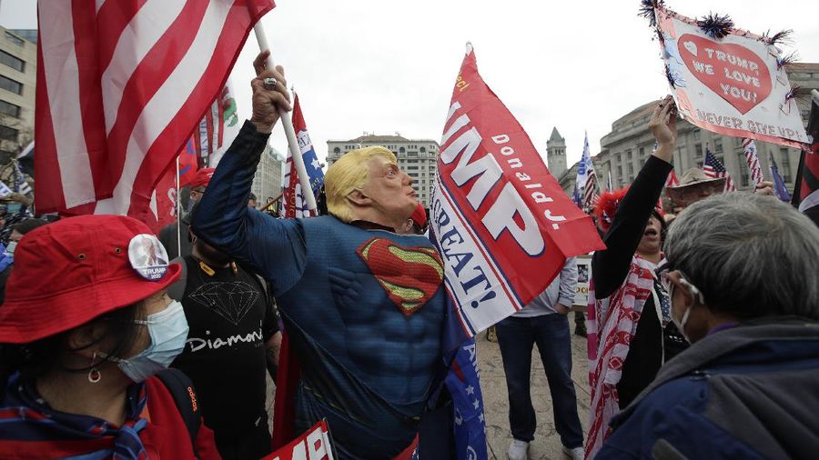 A supporter of President Donald Trump attends a rally at Freedom Plaza, Saturday, Dec. 12, 2020, in Washington. (AP Photo/Luis M. Alvarez)