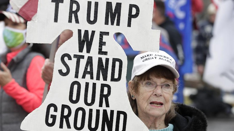 A supporter of President Donald Trump attends a rally at Freedom Plaza, Saturday, Dec. 12, 2020, in Washington. (AP Photo/Luis M. Alvarez)