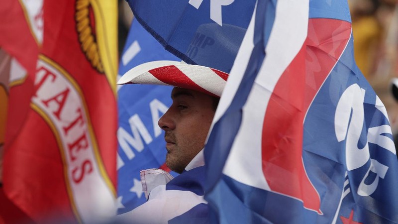 A supporter of President Donald Trump attends a rally at Freedom Plaza, Saturday, Dec. 12, 2020, in Washington. (AP Photo/Luis M. Alvarez)