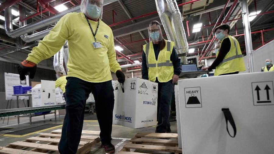 Boxes containing the Pfizer-BioNTech COVID-19 vaccine are prepared to be shipped at the Pfizer Global Supply Kalamazoo manufacturing plant in Portage, Mich., Sunday, Dec. 13, 2020. (AP Photo/Morry Gash, Pool)