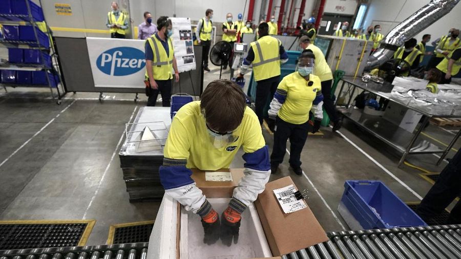 Boxes containing the Pfizer-BioNTech COVID-19 vaccine are prepared to be shipped at the Pfizer Global Supply Kalamazoo manufacturing plant in Portage, Mich., Sunday, Dec. 13, 2020. (AP Photo/Morry Gash, Pool)