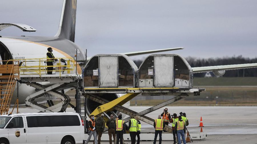 The first shipment of Pfizer-BioNTech COVID-19 vaccines are loaded onto a UPS jet Sunday, Dec. 13, 2020, at Michigan's UPS hub at Capital Region International Airport in Lansing, Mich. (Matthew Dae Smith/Lansing State Journal via AP)