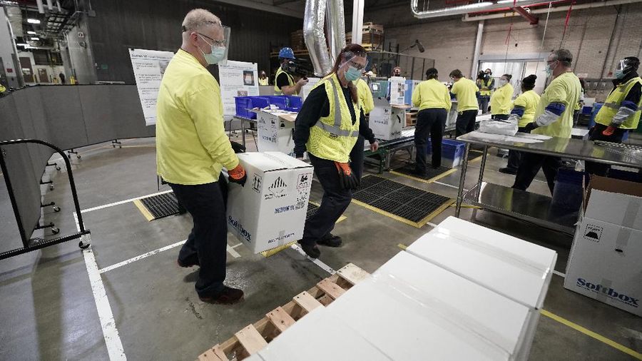 Boxes containing the Pfizer-BioNTech COVID-19 vaccine are prepared to be shipped at the Pfizer Global Supply Kalamazoo manufacturing plant in Portage, Mich., Sunday, Dec. 13, 2020. (AP Photo/Morry Gash, Pool)