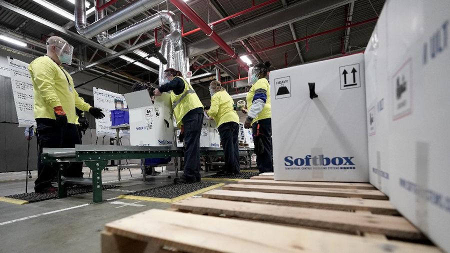 The first shipment of Pfizer-BioNTech COVID-19 vaccines are loaded onto a UPS jet Sunday, Dec. 13, 2020, at Michigan's UPS hub at Capital Region International Airport in Lansing, Mich. (Matthew Dae Smith/Lansing State Journal via AP)