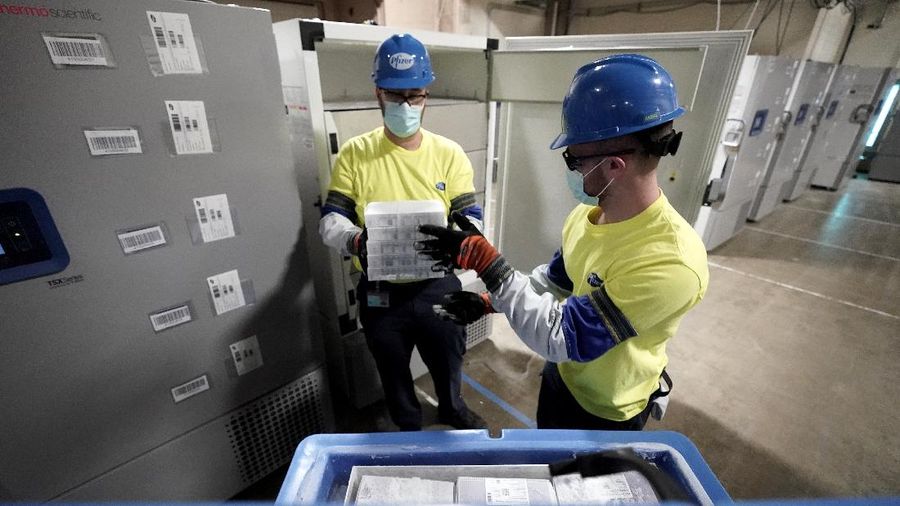 The first shipment of Pfizer-BioNTech COVID-19 vaccines are loaded onto a UPS jet Sunday, Dec. 13, 2020, at Michigan's UPS hub at Capital Region International Airport in Lansing, Mich. (Matthew Dae Smith/Lansing State Journal via AP)