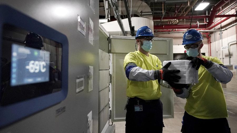 The first shipment of Pfizer-BioNTech COVID-19 vaccines are loaded onto a UPS jet Sunday, Dec. 13, 2020, at Michigan's UPS hub at Capital Region International Airport in Lansing, Mich. (Matthew Dae Smith/Lansing State Journal via AP)