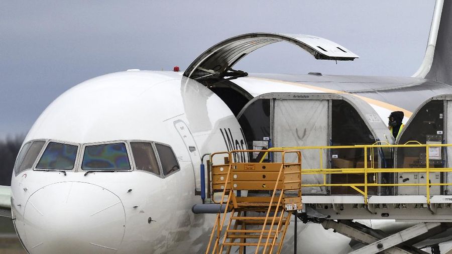 The first shipment of Pfizer-BioNTech COVID-19 vaccines are loaded onto a UPS jet Sunday, Dec. 13, 2020, at Michigan's UPS hub at Capital Region International Airport in Lansing, Mich. (Matthew Dae Smith/Lansing State Journal via AP)