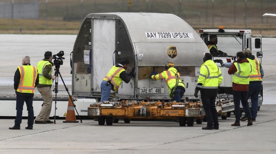 The first shipment of Pfizer-BioNTech COVID-19 vaccines are loaded onto a UPS jet Sunday, Dec. 13, 2020, at Michigan's UPS hub at Capital Region International Airport in Lansing, Mich. (Matthew Dae Smith/Lansing State Journal via AP)