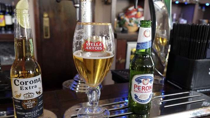 FILE - In this Tuesday, Oct. 13, 2015, file photo, drinks sit on the bar in a pub in London. In 2015, the world's top two beer makers agreed to join forces to create a company that would control nearly a third of the global market. AB InBev's brands include Budweiser, Stella Artois and Corona, while SABMiller produces Peroni and Grolsch. (AP Photo/Kirsty Wigglesworth, File)