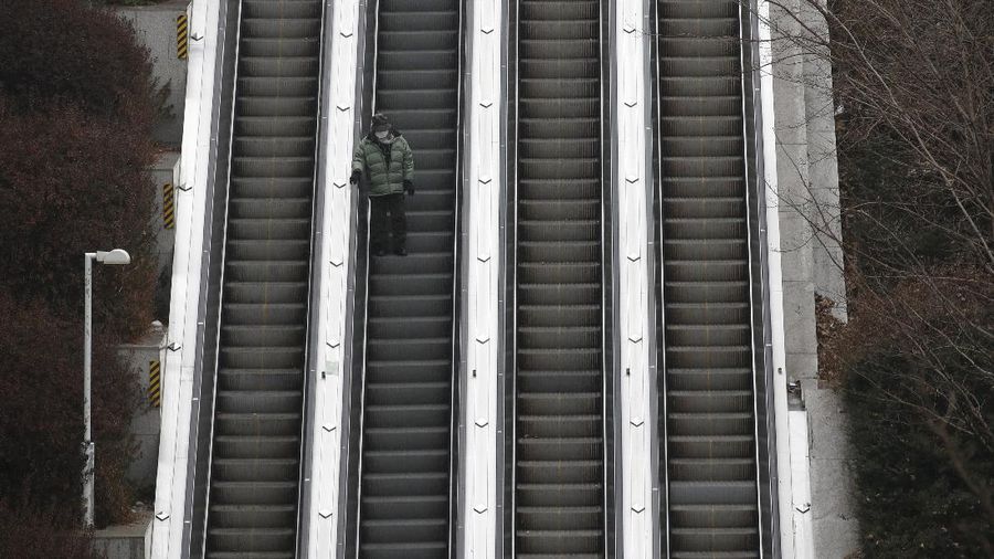 The square in front of the Brandenburg Gate is deserted in Berlin, Germany, early Wednesday, Dec. 16, 2020. In all of Germany, the hard lockdown has begun to slow down the spread of the coronavirus. (Paul Zinken/dpa via AP)