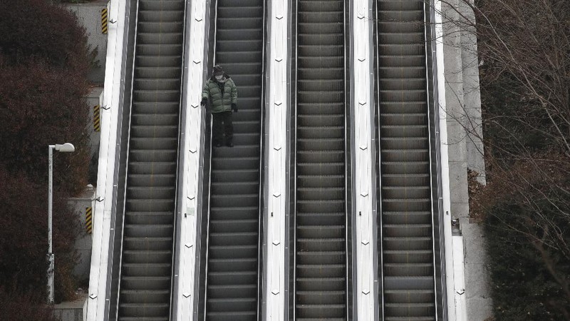 The square in front of the Brandenburg Gate is deserted in Berlin, Germany, early Wednesday, Dec. 16, 2020. In all of Germany, the hard lockdown has begun to slow down the spread of the coronavirus. (Paul Zinken/dpa via AP)
