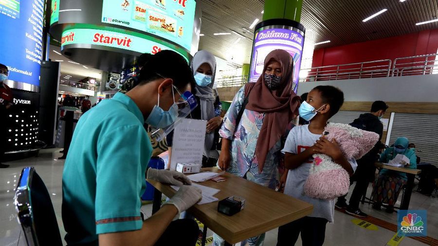 Pemudik terlihat memadati stasiun Gambir, Jakarta Pusat, Kamis (17/12/2020). Mendekati hari Natal dan Tahun baru (NATARU) pemudik pulang ke kampung halaman lebih dulu. (CNBC Indonesia/Tri Susilo)