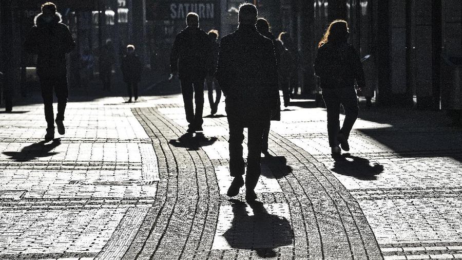 People walk the main shopping street in Cologne Germany, Wednesday, Dec. 16, 2020. Germany has entered a harder lockdown, closing shops and schools in an effort to bring down stubbornly high new cases of the coronavirus. (AP Photo/Martin Meissner)