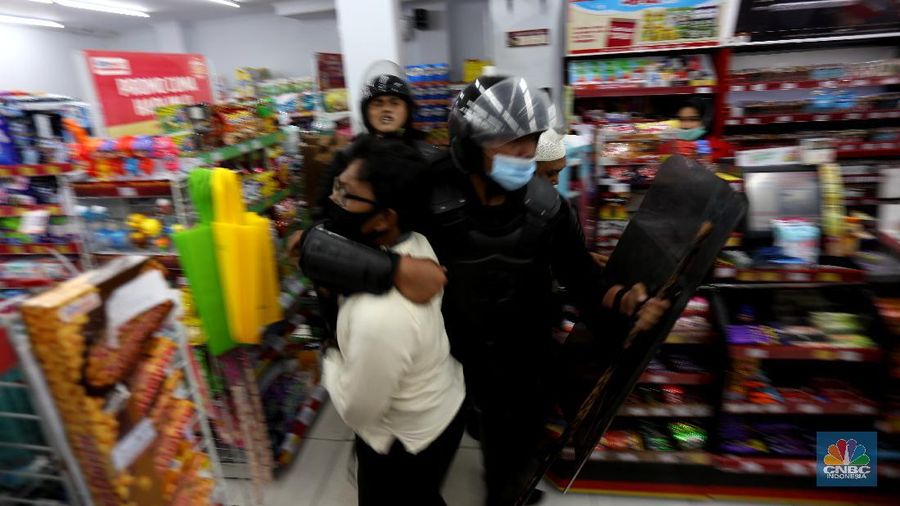Polisi membubarkan massa aksi 1812 di Abdul Muis, Jakarta Pusat, Jumat (18/12/2020). Petugas pengaman dari satuan Brimob dan Polri memukul mundur aksi massa yang akan menerobos masuk brigader polisi. (CNBC Indonesia/Tri Susilo)