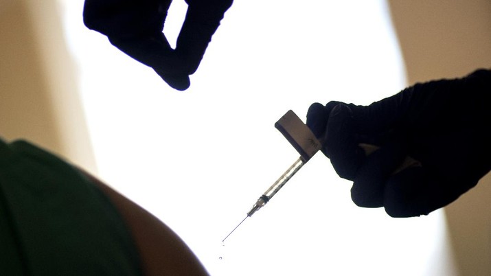 A droplet falls from a syringe after a health care worker is injected with the Pfizer-BioNTech COVID-19 vaccine at Women & Infants Hospital in Providence, R.I., Tuesday, Dec. 15, 2020. (AP Photo/David Goldman)