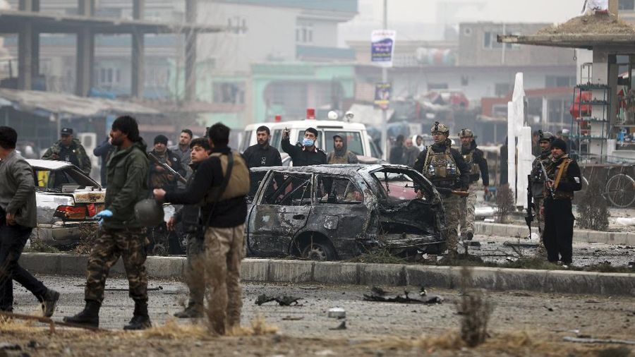 Afghan security personnel inspect the site of a bombing attack in Kabul, Afghanistan, Sunday, Dec. 20, 2020. The strong car bomb explosion rocked the capital Kabul city on Sunday morning, killing multiple people, said a government official. (AP Photo/Rahmat Gul)