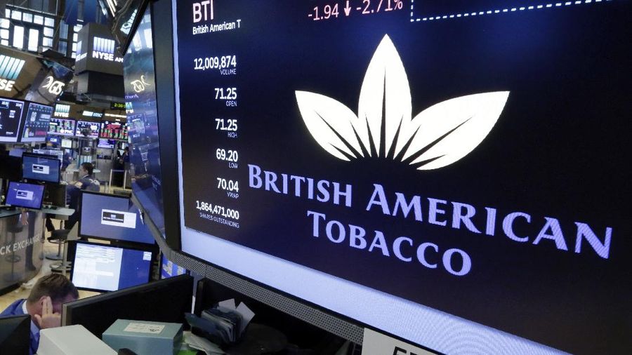 The logo for British American Tobacco appears above a trading post on the floor of the New York Stock Exchange, Monday, July 24, 2017. (AP Photo/Richard Drew)