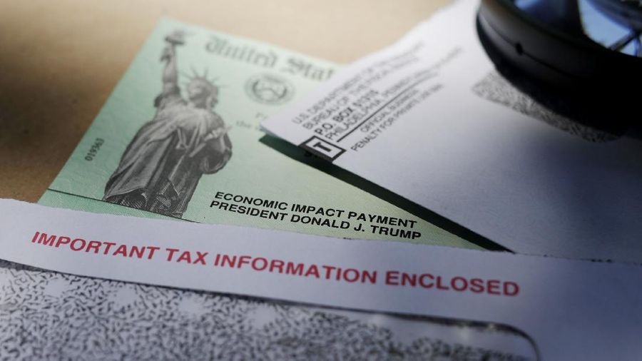In this April 23, 2020, photo, President Donald Trump's name is seen on a stimulus check issued by the IRS to help combat the adverse economic effects of the COVID-19 outbreak, in San Antonio. The US government has distributed about 130 million economic impact payments to taxpayers in less than 30 days. The IRS anticipates sending more than 150 million payments as part of a massive coronavirus rescue package. The distribution has had some hiccups, including an overwhelmed website, payments to deceased taxpayers and money sent to inactive accounts. (AP Photo/Eric Gay)