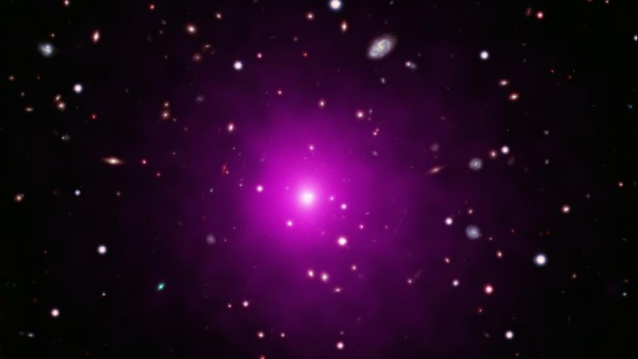 This image of Abell 2261 contains X-ray data from Chandra (pink) showing hot gas pervading the cluster as well as optical data from Hubble and the Subaru Telescope that show galaxies in the cluster and in the background. Astronomers used these telescopes to search galaxy in the center of the image for evidence of a black hole, weighing between 3 and 100 billion times the Sun, that is expected to be there. No sign of this black hole was found, deepening a mystery about what is happening in this system. (X-ray: NASA/CXC/Univ of Michigan/Chandra X-ray Observatory Center)